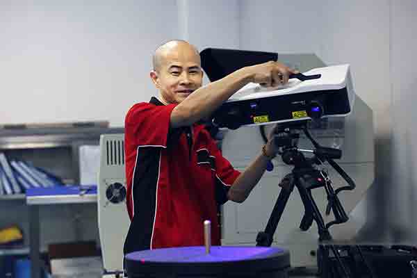 Technician at Michigan CNC Machining Parts, Inc. using Zeiss 3D LED scanner