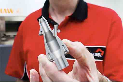 Engineer holding cutaway of 3D printed nozzle at Michigan CNC Machining Parts, Inc.