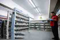 Archie Huang in the paint storage room at Michigan CNC Machining Parts, Inc.