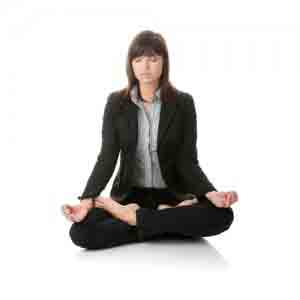 Businesswomen meditating in lotus position.