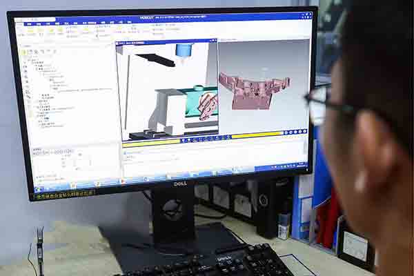 CNC machinist at Michigan CNC Machining Parts, Inc. using Vericut software